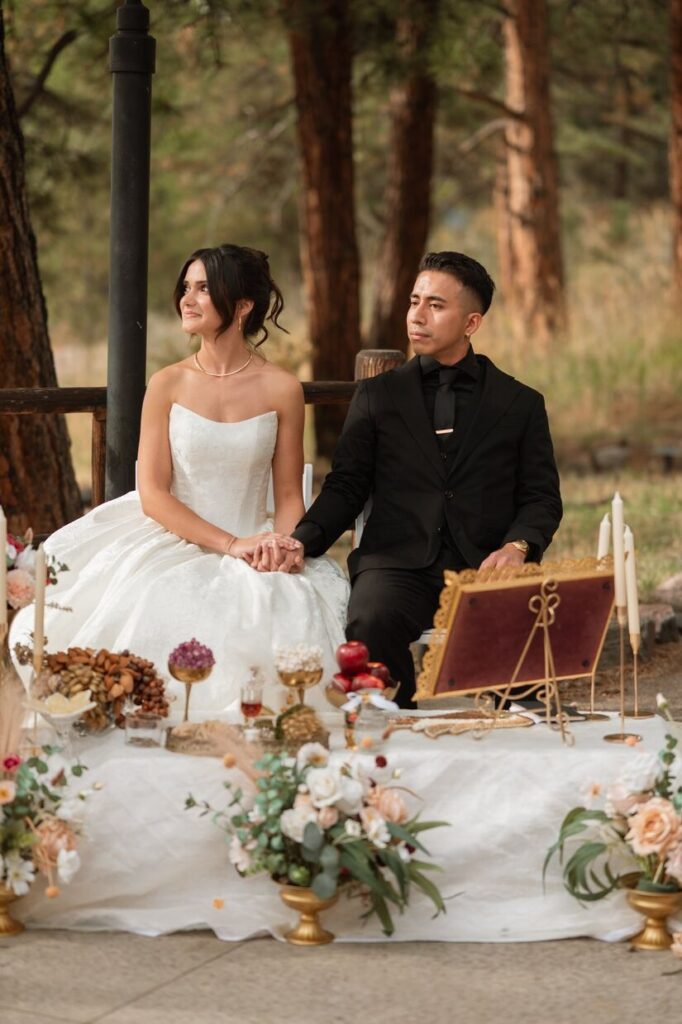 Bride and groom sitting for a ceremony at a micro wedding venue in Colorado
