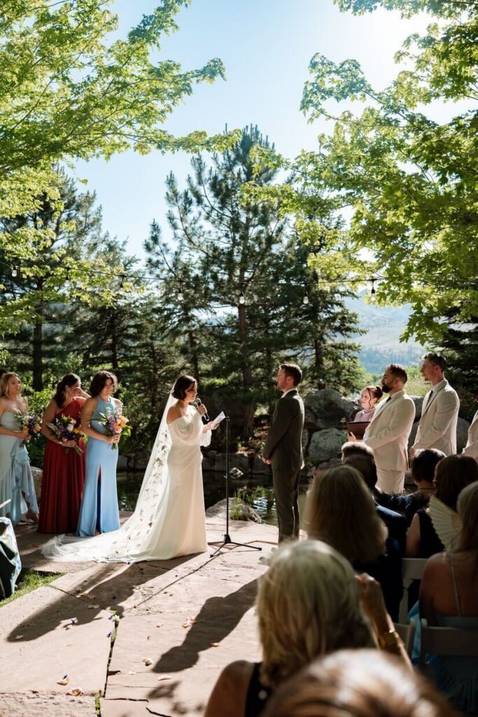 Bride and groom exchanging vows at an outdoor micro wedding venue in Colorado