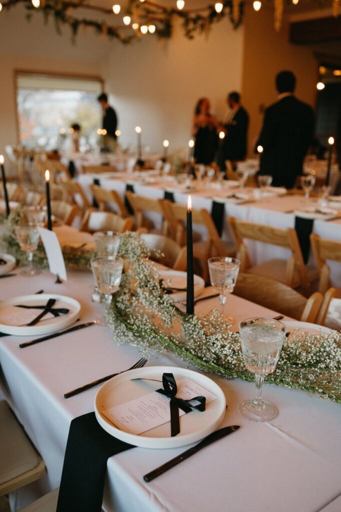 Tables set up with candles for a reception at Rembrandt Yard, a micro wedding venue in Boulder, Colorado