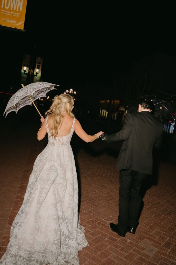Bride and groom strolling the streets near a micro wedding venue in Colorado.
